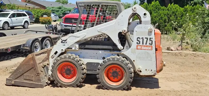 Bobcat S175 and work truck with trailer on a Central Valley job site