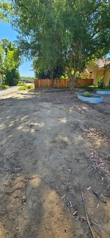 Yard cleaned out and cleared along the fence line
